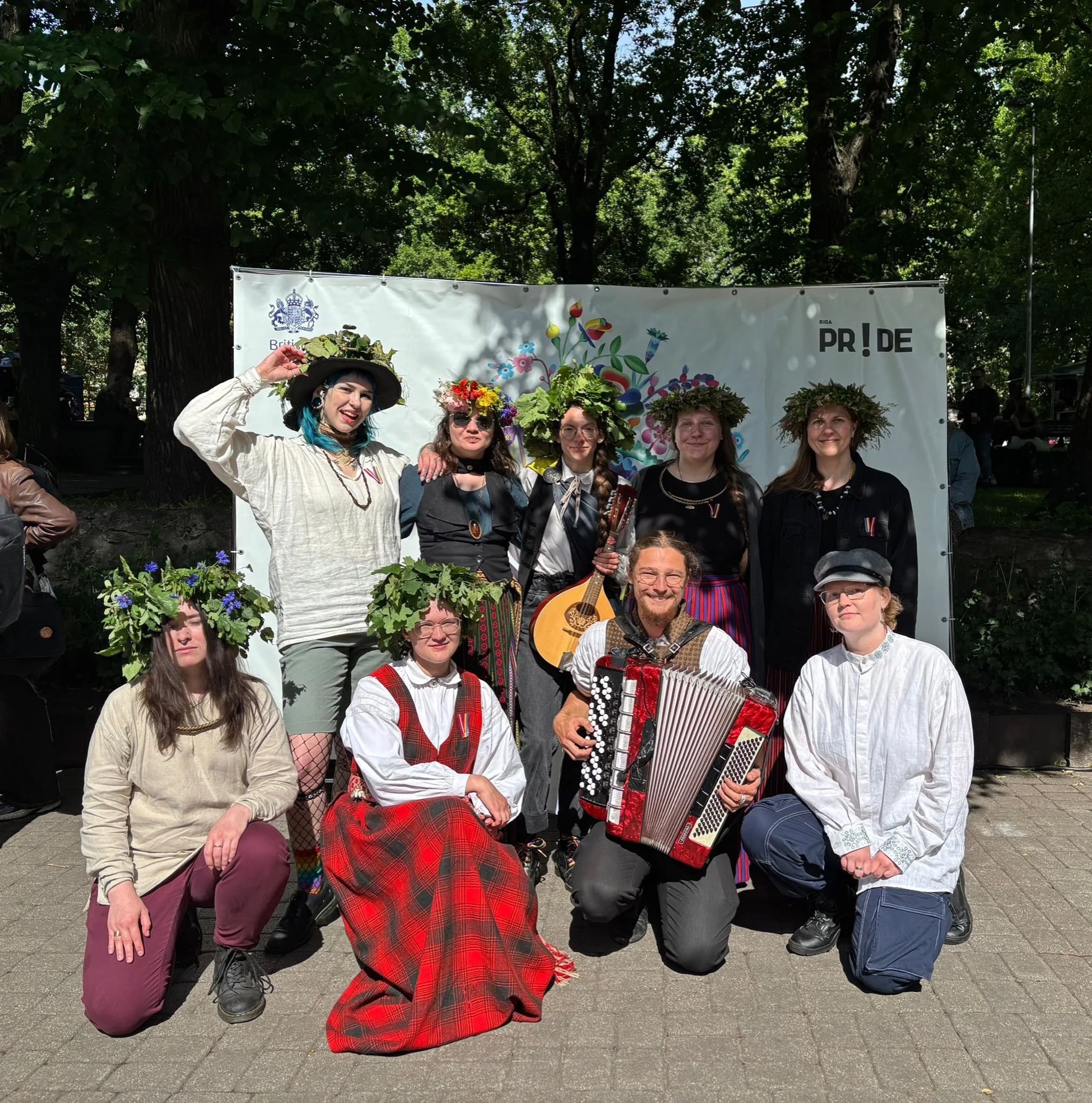 Kvīru folkloras kopa "Priedājs" dalībnieki ar puķu vainagiem "Riga Pride" pasākumā